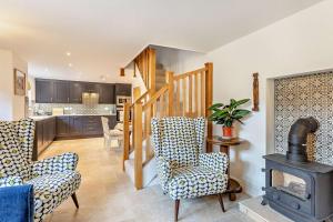 a living room with chairs and a wood stove at 2 Bed in Rede oc-t29450 in Rede