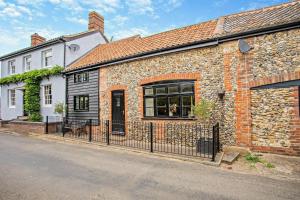 a brick house with a black fence in front of it at 2 Bed in Rede oc-t29450 in Rede