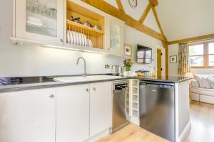 a kitchen with white cabinets and a stainless steel dishwasher at 2 Bed in Little Hereford oc-l29580 in Berrington +17 photos
