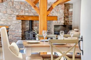 a dining room with a table and chairs and a fireplace at 4 Bed in Nottage oc-t28401 in Nottage