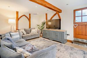 a living room with two couches and a flat screen tv at 4 Bed in Nottage oc-t28401 in Nottage