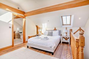 a bedroom with a large white bed and a bathroom at 4 Bed in Nottage oc-t28401 in Nottage