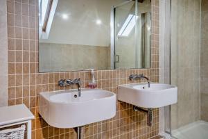 a bathroom with two sinks and a mirror at 4 Bed in Nottage oc-t28401 in Nottage +22 photos