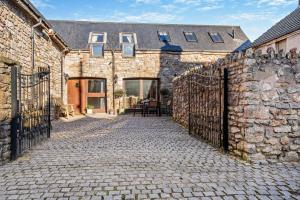 an old stone building with a gate and a patio at 4 Bed in Nottage oc-t28401 in Nottage