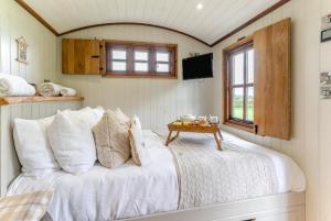 a bedroom with a white bed with a table at 1 Bed in Bronllys oc-t31949 in Bronllys