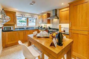a kitchen with a wooden table and white chairs at 3 Bed in Goldenbank oc-c29977 in Falmouth