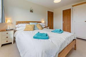 a bedroom with a white bed with two towels on it at 3 Bed in Goldenbank oc-c29977 in Falmouth