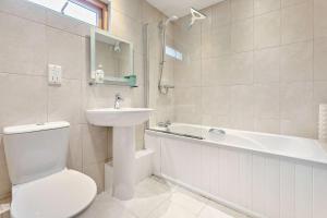 a bathroom with a toilet and a sink and a tub at 3 Bed in Goldenbank oc-c29977 in Falmouth +18 photos