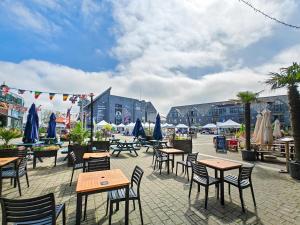 an outdoor patio with tables and chairs and umbrellas at 3 Bed in Goldenbank oc-c29977 in Falmouth