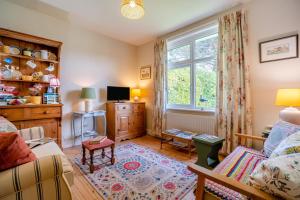 a living room with a couch and a window at 2 Bed in Dymchurch oc-s31998 in Dymchurch