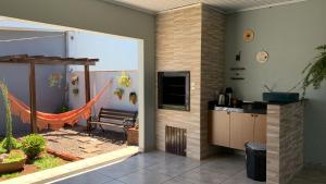 a room with a patio with a hammock at Pousada Selenita in Ametista do Sul