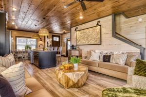 a living room with a couch and a table at Firefly Lodge - Pool, Theatre, Dog Friendly! in Pigeon Forge