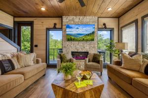 a living room with a couch and a fireplace at Firefly Lodge - Pool, Theatre, Dog Friendly! in Pigeon Forge +72 photos