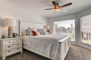 a bedroom with a bed and a ceiling fan at Shipwrecked Getaway For 6 in Galveston