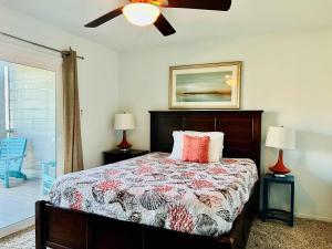 a bedroom with a bed and a ceiling fan at Shipwrecked Getaway For 6 in Galveston