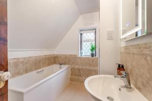 a bathroom with a bath tub and a sink at 2 Bed in Charing oc-r29113 in Charing +14 photos