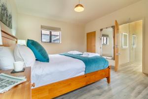 a bedroom with a large bed with blue pillows at 3 Bed in Heveningham oc-w29031 in Heveningham