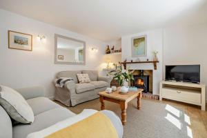 a living room with a couch and a fireplace at 2 Bed in Dersingham oc-b27417 in Dersingham