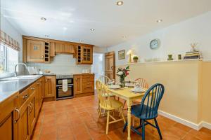 a kitchen with a table and chairs in a kitchen at 2 Bed in Dersingham oc-b27417 in Dersingham