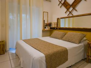 a bedroom with a large bed with a large mirror at Hotel Natural Brotas - SPA & Lazer in Brotas +102 photos