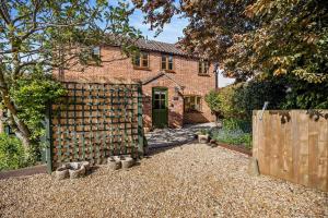 a brick house with a fence in front of it at 2 Bed in Dersingham oc-b27417 in Dersingham