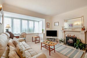 a living room with a couch and a fireplace at 3 Bed in Thornham oc-m28084 in Thornham