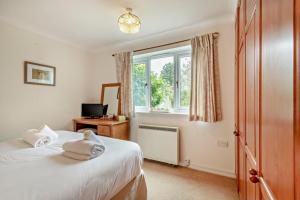 a bedroom with two beds and a window at 3 Bed in Thornham oc-m28084 in Thornham
