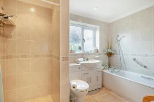 a bathroom with a toilet and a tub and a sink at 3 Bed in Thornham oc-m28084 in Thornham +20 photos