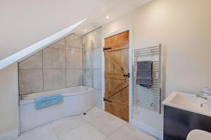 a bathroom with a bath tub and a sink at 2 Bed in Feering oc-p29293 in Feering +18 photos