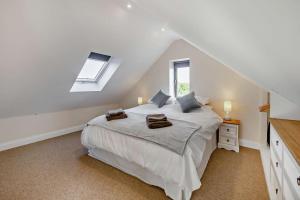 a bedroom with a large bed in a attic at 2 Bed in Feering oc-p29293 in Feering
