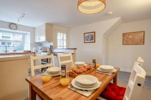 a kitchen with a wooden table with plates on it at 2 Bed in Hawes oc-ds1041 in Hawes