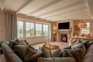 a living room with a large couch and a fireplace at 3 Bed in Wittersham oc-m27683 in Wittersham