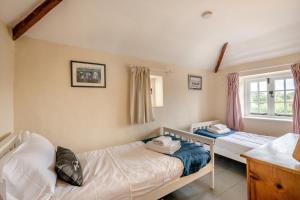 a bedroom with two beds and a window at 2 Bed in Burnham Overy Staithe oc-p30460 in Burnham Market