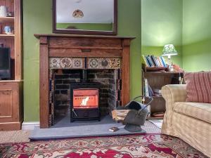 a living room with a fireplace with a television above it at 3 Bed in Swanage oc-s30316 in Swanage