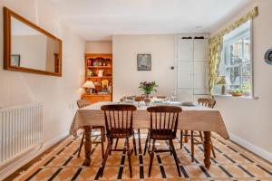 a dining room with a wooden table and chairs at 3 Bed in Swanage oc-s30316 in Swanage