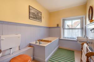 a bathroom with a tub and a sink and a window at 3 Bed in Swanage oc-s30316 in Swanage +17 photos