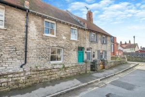 a brick house with a green door on a street at 3 Bed in Swanage oc-s30316 in Swanage