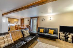 a living room with a leather couch and a television at 2 Bed in Eggleston oc-l30452 in Middleton in Teesdale