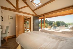 two beds in a bedroom with a large window at 2 Bed in Allendale oc-r29078 in Allendale Town