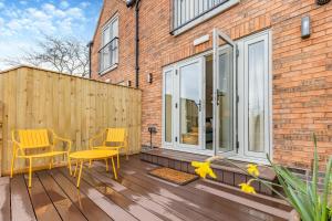 a patio with two chairs and a yellow table at 1 Bed in Pershore oc-t29049 in Pershore