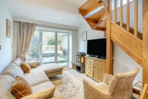 a living room with a couch and a television at 2 Bed in Pooley Bridge oc-l31060 in Pooley Bridge