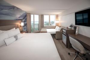 a hotel room with a large white bed and a desk at Coast Bastion Hotel in Nanaimo +44 photos