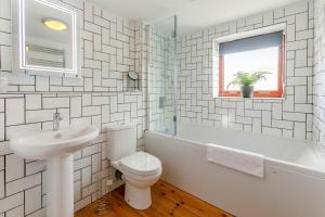 a white bathroom with a toilet and a sink at 3 Bed in Coverack oc-b31082 in Coverack +15 photos