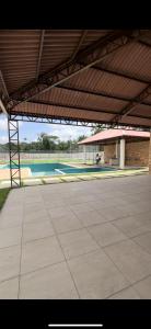 a large patio with a pool and a building at Flor Da Amazônia 2, Vista para o Bosque in Ananindeua