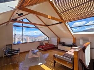 a living room with large windows and a couch at Villa Florita in La Paz