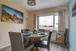 a dining room with a table and chairs and a window at 3 Bed in Lucker oc-nb1938 in Lucker