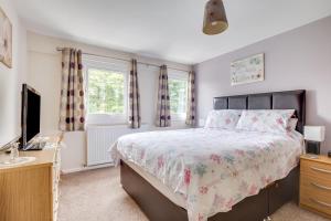 a bedroom with a bed and a television at 3 Bed in Lucker oc-nb1938 in Lucker