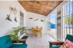 a living room with a table and views of the ocean at The blue wave in Willemstad