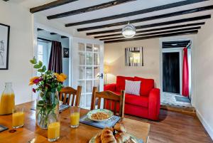 a living room with a table and a red couch at 2 Bed in Brancaster oc-b28394 in Brancaster