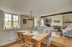 a dining room and living room with a wooden table at 2 Bed in Little Barningham oc-1817 in Little Barningham